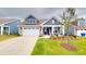 Charming two-story home with a manicured lawn, a two-car garage, and a covered front porch at 1720 Pinecliff Ct, Fuquay Varina, NC 27526