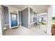 Inviting front porch features a blue door, neutral siding, and a cozy seating area at 1720 Pinecliff Ct, Fuquay Varina, NC 27526