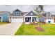 Charming home featuring a two-car garage, manicured lawn and tasteful landscaping at 1720 Pinecliff Ct, Fuquay Varina, NC 27526