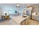 Bright kitchen with stainless steel appliances, island with quartz countertop, and an open floorplan at 1720 Pinecliff Ct, Fuquay Varina, NC 27526