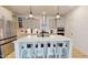 Modern kitchen features a large island with seating and stainless steel appliances at 1720 Pinecliff Ct, Fuquay Varina, NC 27526