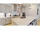 Modern kitchen featuring stainless steel appliances, white cabinets, subway tile backsplash, and quartz countertops at 1720 Pinecliff Ct, Fuquay Varina, NC 27526