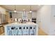 Modern kitchen features a large island with seating and stainless steel appliances at 1720 Pinecliff Ct, Fuquay Varina, NC 27526