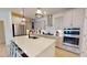 Modern kitchen with white cabinets, a large island, and stainless steel appliances at 1720 Pinecliff Ct, Fuquay Varina, NC 27526