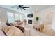 Relaxing living room featuring a ceiling fan, fireplace, and neutral colors at 1720 Pinecliff Ct, Fuquay Varina, NC 27526