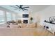 Open-concept living room with a fireplace, TV, and lots of seating for guests to relax and enjoy themselves at 1720 Pinecliff Ct, Fuquay Varina, NC 27526