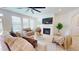 Inviting living room featuring a fireplace, large windows, and neutral décor, perfect for relaxation and entertaining at 1720 Pinecliff Ct, Fuquay Varina, NC 27526