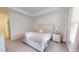 Bright main bedroom featuring tray ceilings, plush carpeting, and large windows with charming window treatments at 1720 Pinecliff Ct, Fuquay Varina, NC 27526