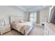 Serene main bedroom with tray ceilings, neutral color palette, and ample natural light from a large window at 1720 Pinecliff Ct, Fuquay Varina, NC 27526