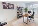 Well-lit home office with modern desk, shelving, and a comfortable work space with a large window at 1720 Pinecliff Ct, Fuquay Varina, NC 27526