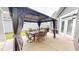 Back patio features an elegant outdoor dining set under a covered gazebo, perfect for entertaining at 1720 Pinecliff Ct, Fuquay Varina, NC 27526