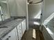 Bright bathroom featuring double vanity, granite countertops, and access to the bedroom at 176 Bonsai Way, Four Oaks, NC 27524