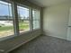 Well-lit bedroom with carpeting, neutral walls, and picturesque window views at 176 Bonsai Way, Four Oaks, NC 27524