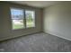 Cozy bedroom with plush carpeting, neutral walls and a bright view outside the windows at 176 Bonsai Way, Four Oaks, NC 27524
