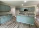 Modern kitchen boasts granite countertops, stainless steel appliances, and a stylish kitchen island at 176 Bonsai Way, Four Oaks, NC 27524
