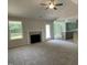 Open-concept living room with fireplace flowing into a stylish kitchen at 176 Bonsai Way, Four Oaks, NC 27524