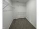Functional walk-in closet equipped with wire shelving and carpeted flooring at 176 Bonsai Way, Four Oaks, NC 27524