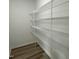 Walk-in closet featuring sturdy wire shelving and vinyl plank flooring at 176 Bonsai Way, Four Oaks, NC 27524