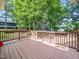 A wooden deck with railing overlooks the backyard at 1825 Watkins St, Raleigh, NC 27604