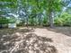 Spacious, partially shaded backyard, featuring mature trees and a fire pit, ideal for outdoor entertaining at 1825 Watkins St, Raleigh, NC 27604