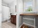 Cozy bathroom with tile floors, storage shelving, and a window for natural light at 1825 Watkins St, Raleigh, NC 27604