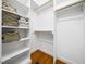 Organized walk-in closet with built-in shelves and rods for storage at 1825 Watkins St, Raleigh, NC 27604