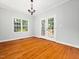 Bright dining room featuring hardwood floors, natural light, and French doors to the outside deck at 1825 Watkins St, Raleigh, NC 27604