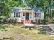 Charming home featuring a welcoming front porch, tasteful landscaping, and classic architectural details at 1825 Watkins St, Raleigh, NC 27604
