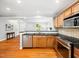 Kitchen featuring stainless steel appliances, granite counters, and an open view into the living space at 1825 Watkins St, Raleigh, NC 27604