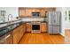 Functional kitchen featuring wood cabinetry, stainless steel appliances, and granite countertops at 1825 Watkins St, Raleigh, NC 27604
