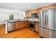 Modern kitchen with stainless steel appliances, granite countertops, and wood cabinets at 1825 Watkins St, Raleigh, NC 27604