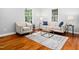 Inviting living room boasts hardwood floors, comfortable seating, and large windows for natural light at 1825 Watkins St, Raleigh, NC 27604
