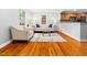 Bright and airy living room with hardwood floors and an open layout leading into the kitchen area at 1825 Watkins St, Raleigh, NC 27604
