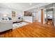 Bright living room with hardwood floors, neutral paint, and an open flow to the kitchen at 1825 Watkins St, Raleigh, NC 27604
