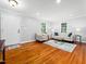 Spacious living room features hardwood floors, neutral décor, and large windows for ample natural light at 1825 Watkins St, Raleigh, NC 27604