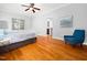 Spacious main bedroom featuring hardwood floors, a ceiling fan and ensuite bathroom access at 1825 Watkins St, Raleigh, NC 27604