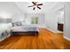 Comfortable main bedroom featuring hardwood floors and ensuite bathroom access at 1825 Watkins St, Raleigh, NC 27604