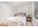 This bedroom features a queen bed, carpeted floors, and two nightstands at 1851 Trailwood Heights Ln # 204, Raleigh, NC 27603