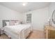 Neutral bedroom with a queen bed, a light wood dresser and a large window at 1851 Trailwood Heights Ln # 204, Raleigh, NC 27603