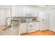 Bright kitchen with white cabinets, modern appliances, and hardwood floors at 1851 Trailwood Heights Ln # 204, Raleigh, NC 27603