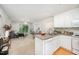 Kitchen open to the living room featuring white cabinets and essential appliances at 1851 Trailwood Heights Ln # 204, Raleigh, NC 27603