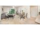Bright living room with a ceiling fan, dining area, balcony access, and neutral carpet at 1851 Trailwood Heights Ln # 204, Raleigh, NC 27603
