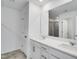 Bright bathroom featuring a double vanity with white countertops, a large mirror, and tile flooring at 2010 Nebula Way, Durham, NC 27703