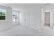 Carpeted bedroom with a window and a doorway leading to the bathroom at 2010 Nebula Way, Durham, NC 27703