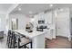 Bright kitchen displays a white island, stainless appliances, and three barstools at 2010 Nebula Way, Durham, NC 27703
