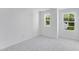 Bedroom with two windows, light gray carpet and white walls at 2019 Nebula Way, Durham, NC 27703