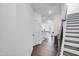 Bright entryway with wood floors leading into a modern kitchen and a staircase at 2019 Nebula Way, Durham, NC 27703