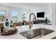 Bright, modern kitchen featuring a stainless steel sink, stylish faucet, and an open view to the living area at 2019 Nebula Way, Durham, NC 27703