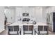 Contemporary kitchen with stainless appliances, central island with barstool seating, and white cabinetry at 2019 Nebula Way, Durham, NC 27703