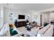 Comfortable living room with white sofas, stylish decor, and a large TV for entertaining at 2019 Nebula Way, Durham, NC 27703